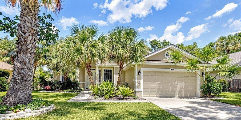 Charming Jacksonville home with palm trees and greenery.