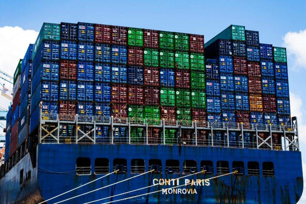 Stacked cargo containers on a massive ship at the harbor, symbolizing global trade.