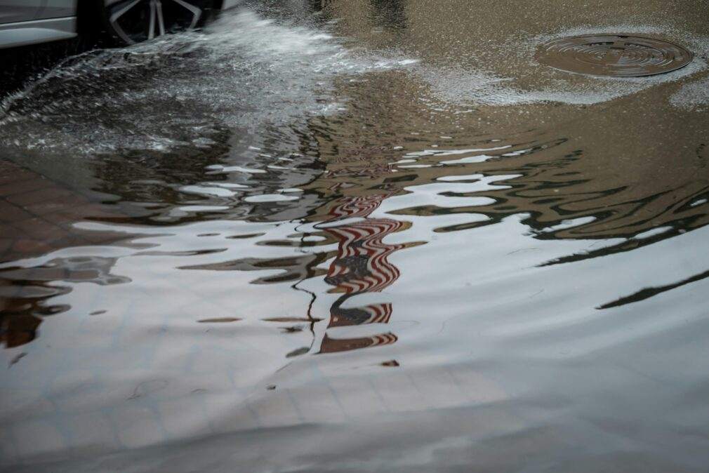 Flooded street with water reflections in Savannah, Georgia. Urban rain aftermath.