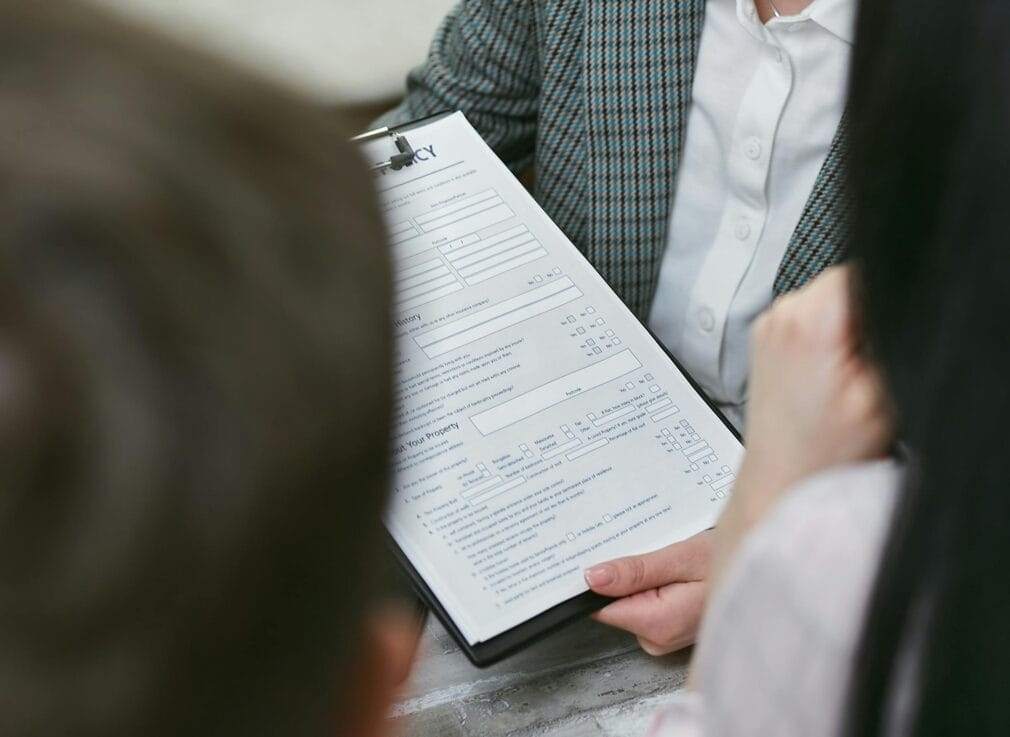 Close-up of professionals discussing a legal contract during a business meeting.