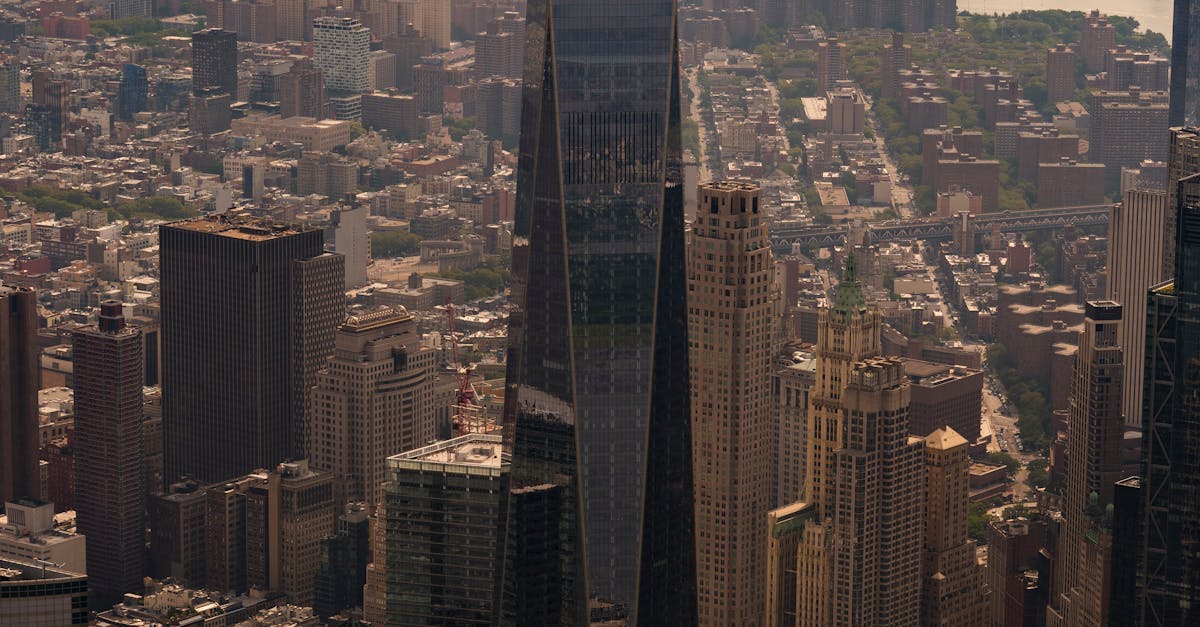 Stunning aerial view of One World Trade Center towering over New York City skyline with Hudson River
